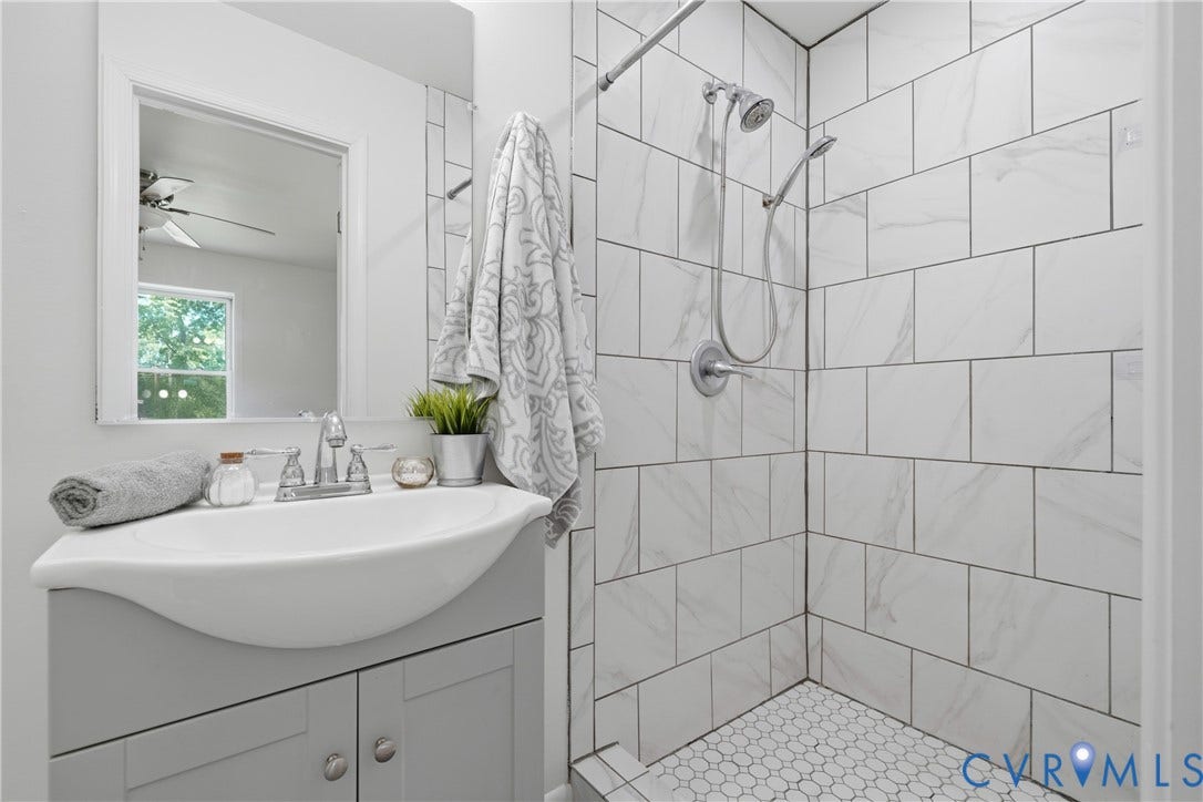 1214 Southbury Avenue, Henrico, VA 23231 Bathroom featuring a shower with white subway tile surround and a hexagonal tile floor