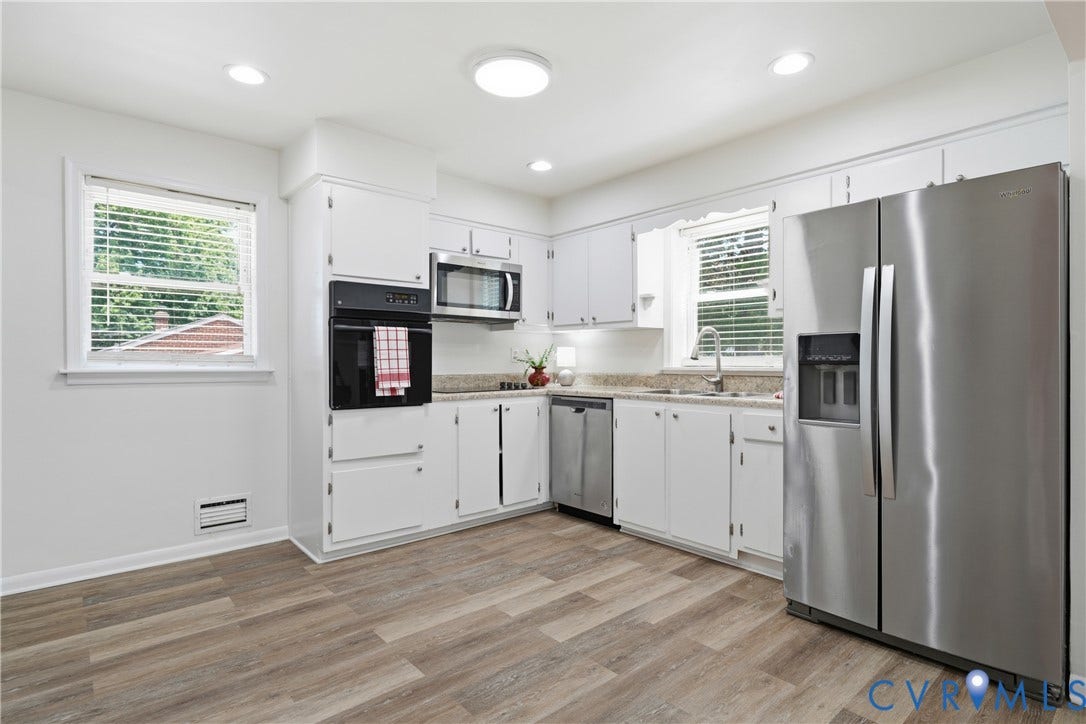 1214 Southbury Avenue, Henrico, VA 23231 Kitchen featuring wood-finish flooring, white cabinetry, integrated wall oven, and a stainless steel appliance suite