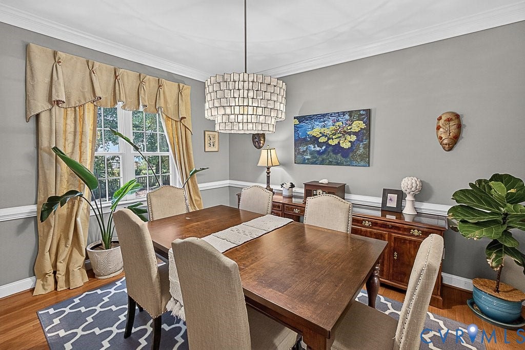 705 Lakewater Drive, Henrico, VA 23229 Dining area featuring hardwood flooring and a contemporary tiered chandelier