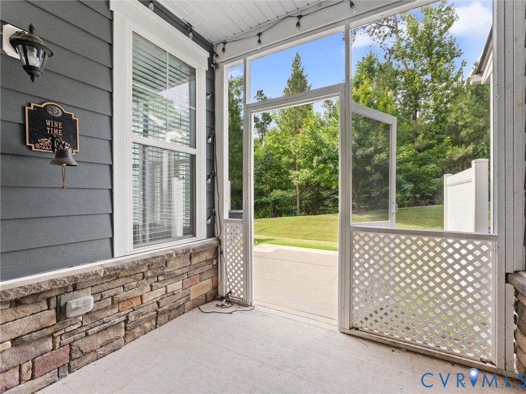 17455 Memorial Tournament Drive, Wynestone Park, Moseley, VA 23120 screened in porch leading to patio and rear wooded lot