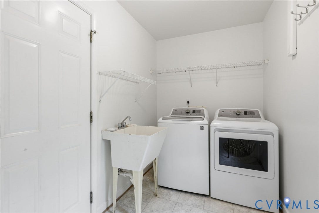 Dedicated utility space featuring a utility sink, upper wire shelving, and durable flooring