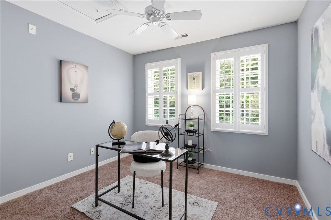Interior room with light gray walls, brown carpeting, and white trim
