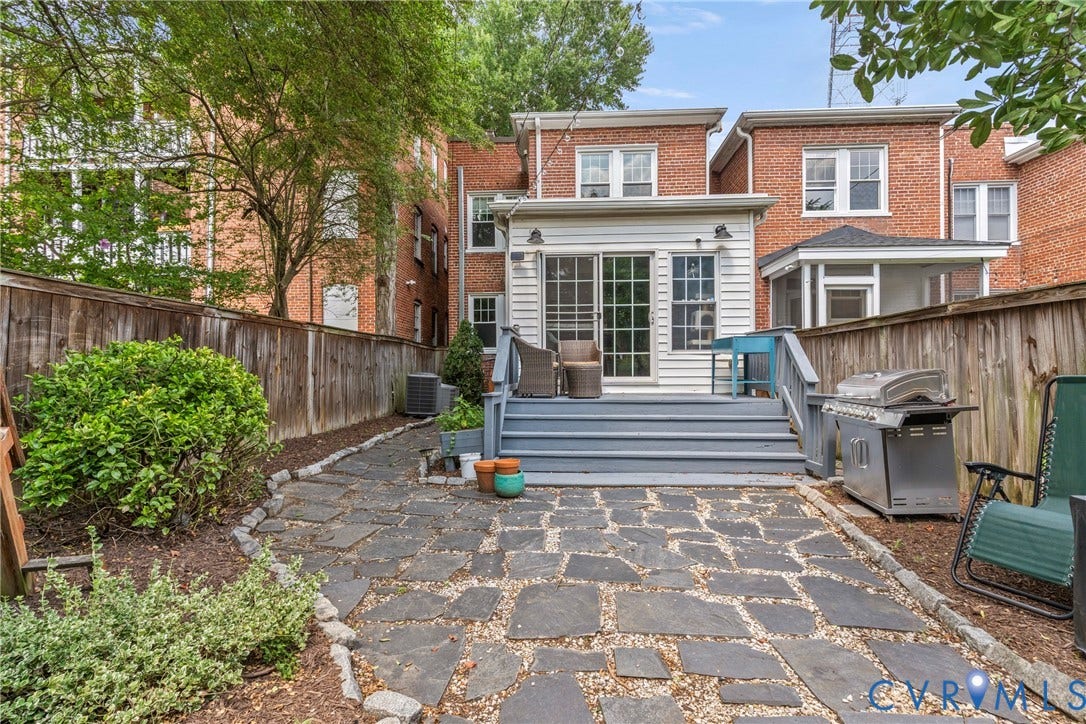 3331 W Grace Street, Monument Avenue, Richmond, VA 23221 Outdoor patio featuring flagstone pavers, a wooden privacy fence, and mature landscaping