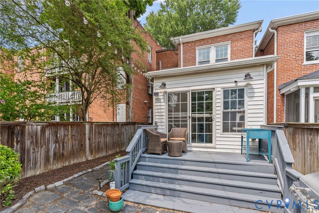 3331 W Grace Street, Monument Avenue, Richmond, VA 23221 Rear exterior featuring a spacious deck with gray painted stairs and railings, leading to a stone patio