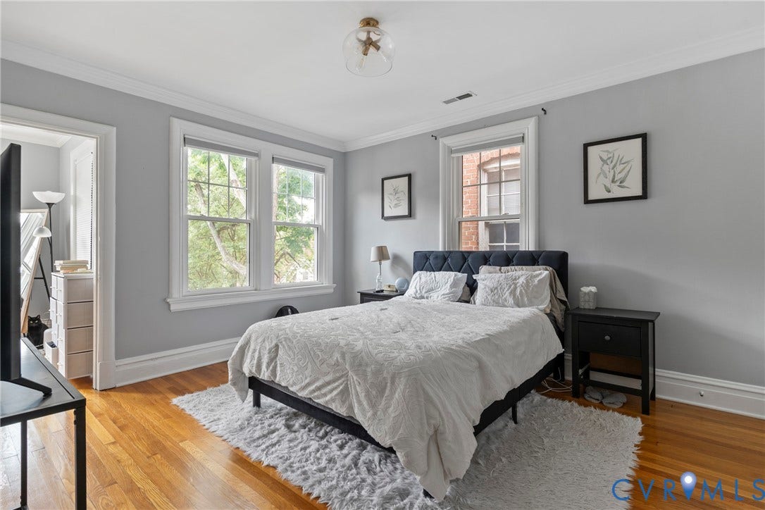 3331 W Grace Street, Monument Avenue, Richmond, VA 23221 Light-filled room featuring wood-finish flooring, two window units with white trim, and crown molding