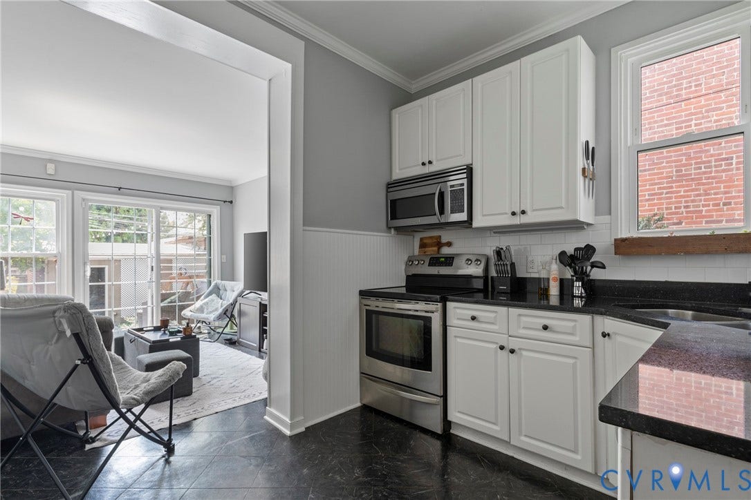 3331 W Grace Street, Monument Avenue, Richmond, VA 23221 Kitchen featuring white cabinetry, black countertops, stainless steel appliances, and white subway tile backsplash