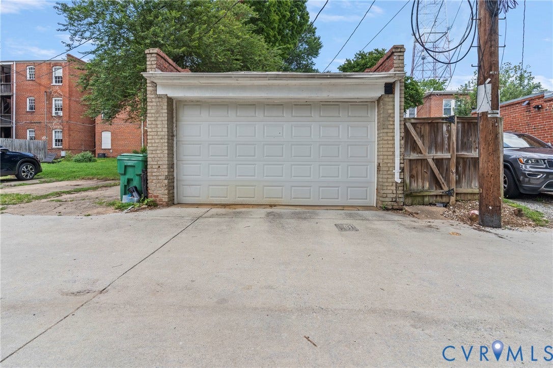 3331 W Grace Street, Monument Avenue, Richmond, VA 23221 Detached garage featuring a paneled door, light brick pillars, and concrete apron