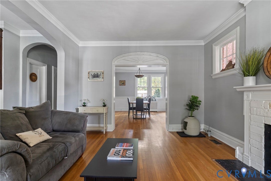3331 W Grace Street, Monument Avenue, Richmond, VA 23221 Spacious living area featuring hardwood flooring, white crown molding, and a painted brick fireplace