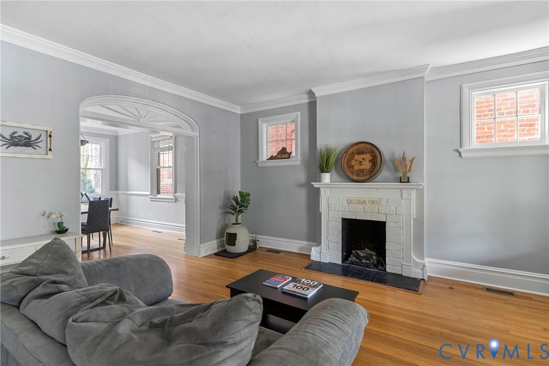3331 W Grace Street, Monument Avenue, Richmond, VA 23221 Living area featuring wood-finish flooring, an ornate fireplace with a white mantel and brick surround, and crown molding
