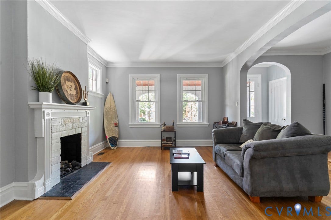 3331 W Grace Street, Monument Avenue, Richmond, VA 23221 Bright living space featuring hardwood flooring and a fireplace with a white brick surround and black hearth
