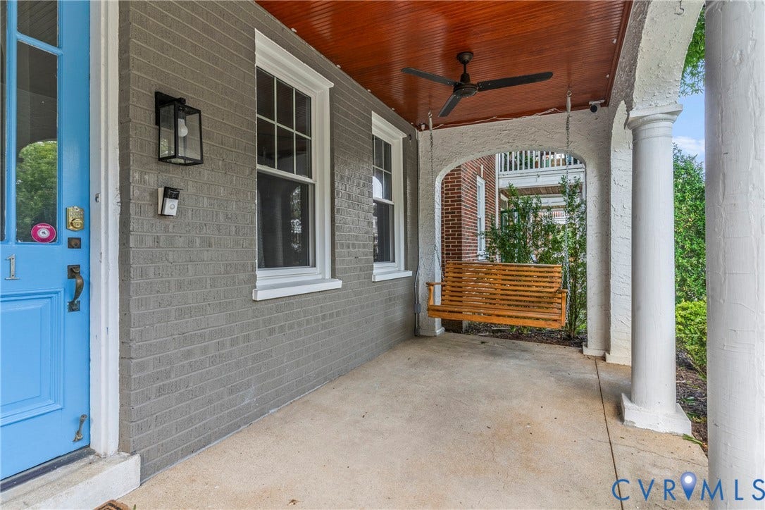 3331 W Grace Street, Monument Avenue, Richmond, VA 23221 Inviting porch featuring gray brickwork, a bright blue entry door, and white trim windows
