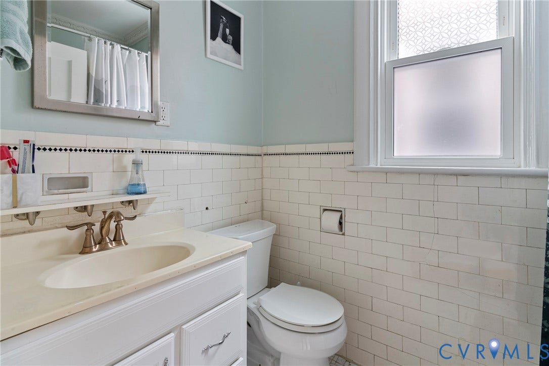 3331 W Grace Street, Monument Avenue, Richmond, VA 23221 Bathroom featuring subway tile wainscoting, a white vanity with an integrated sink, and a window with privacy film