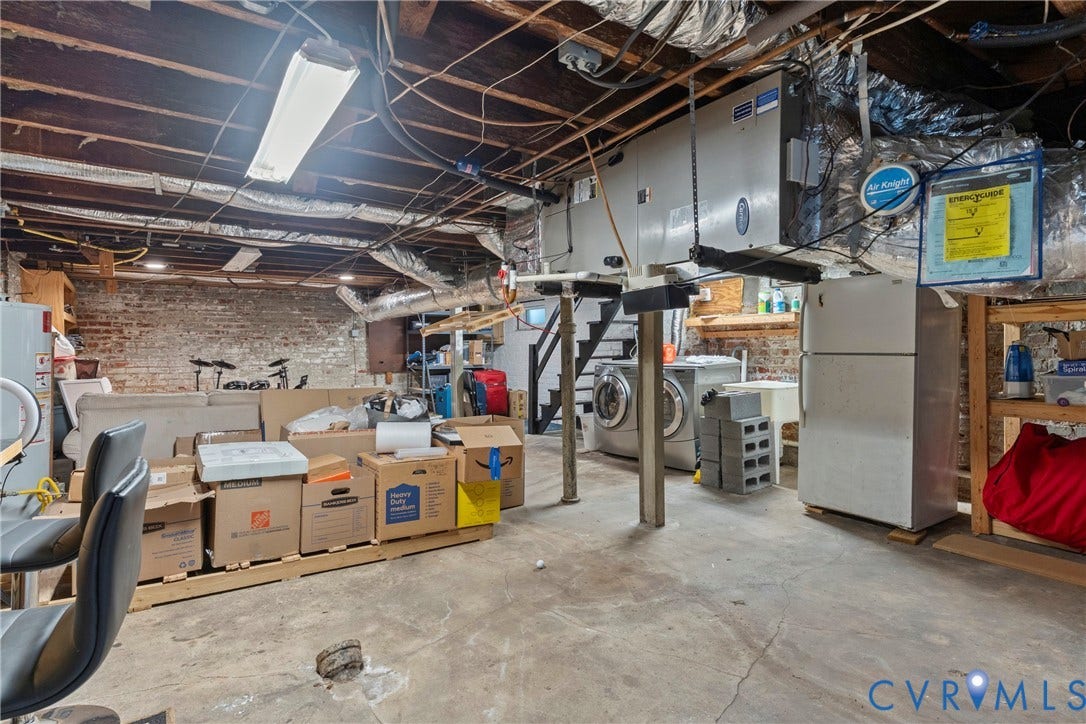 3331 W Grace Street, Monument Avenue, Richmond, VA 23221 Unfinished basement space featuring exposed brick walls, concrete flooring, and visible ceiling joists