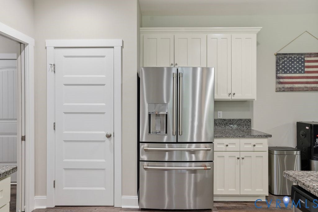 3259 Three Bridge Road, Powhatan, VA 23139 Modern kitchen featuring stainless steel French door refrigerator, white shaker-style cabinetry, dark speckled countertops, and wood-finish flooring