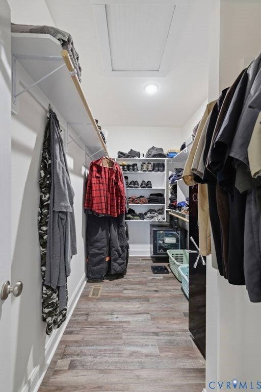 3259 Three Bridge Road, Powhatan, VA 23139 Walk-in closet featuring wood-finish flooring, recessed lighting, white built-in shelving, and hanging rods