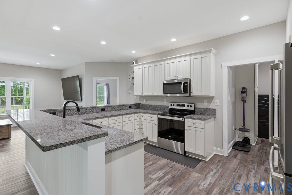 3259 Three Bridge Road, Powhatan, VA 23139 Kitchen featuring white shaker-style cabinetry, granite countertops, stainless steel appliances, and wood-finish flooring