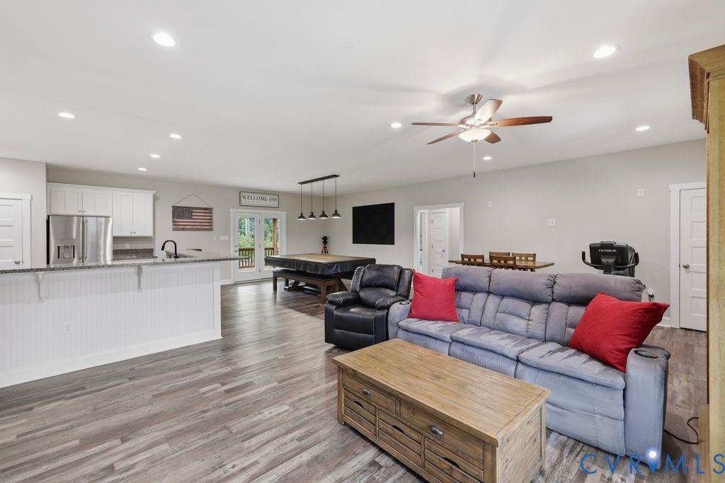 3259 Three Bridge Road, Powhatan, VA 23139 Spacious open-concept living area featuring wood-finish flooring, recessed lighting, and a ceiling fan