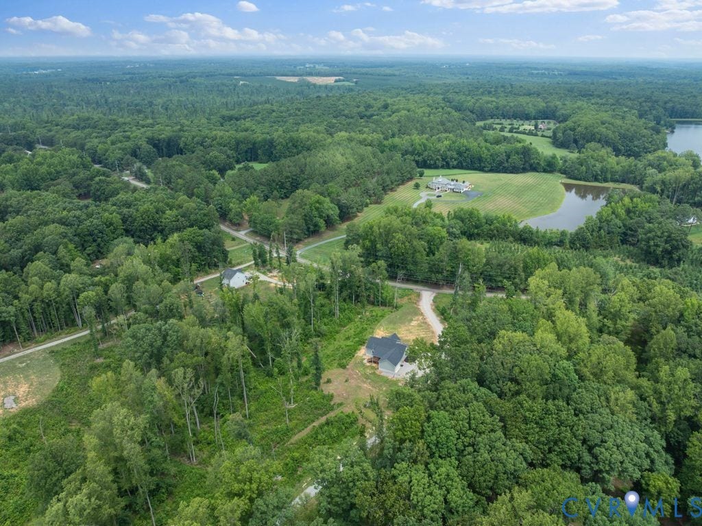 3259 Three Bridge Road, Powhatan, VA 23139 Expansive wooded acreage featuring a single-family residence with a dark roof