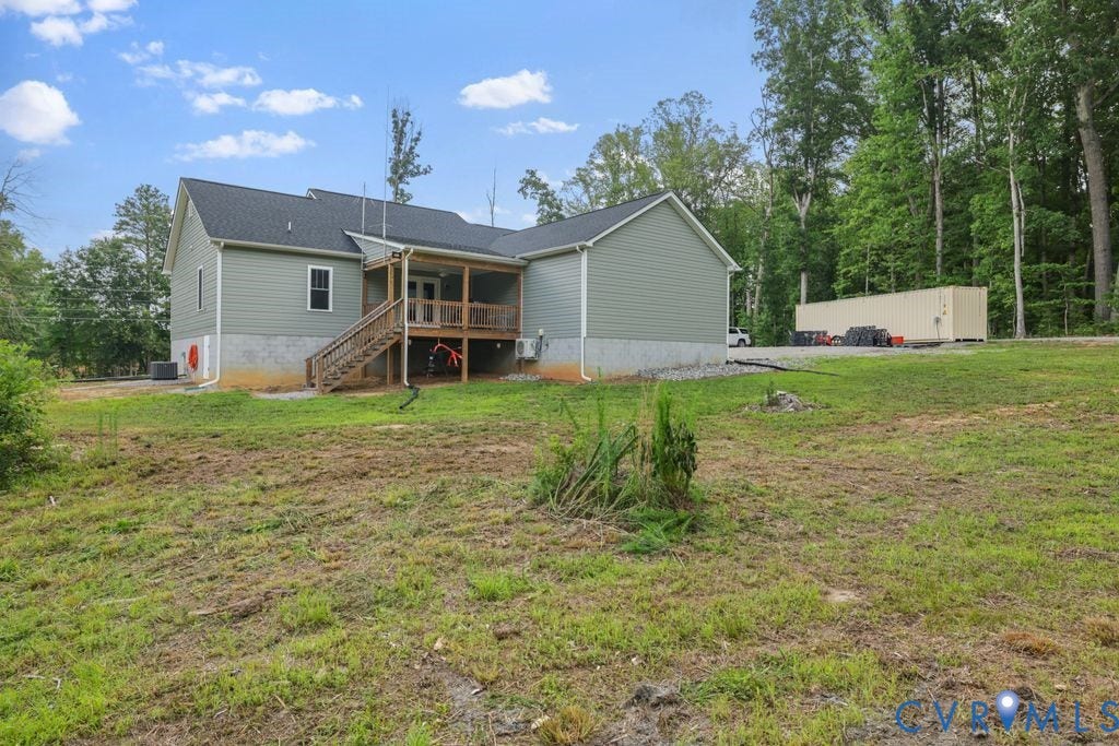 3259 Three Bridge Road, Powhatan, VA 23139 Rear exterior featuring light green siding, dark shingle roof, and a covered back porch with wood railing