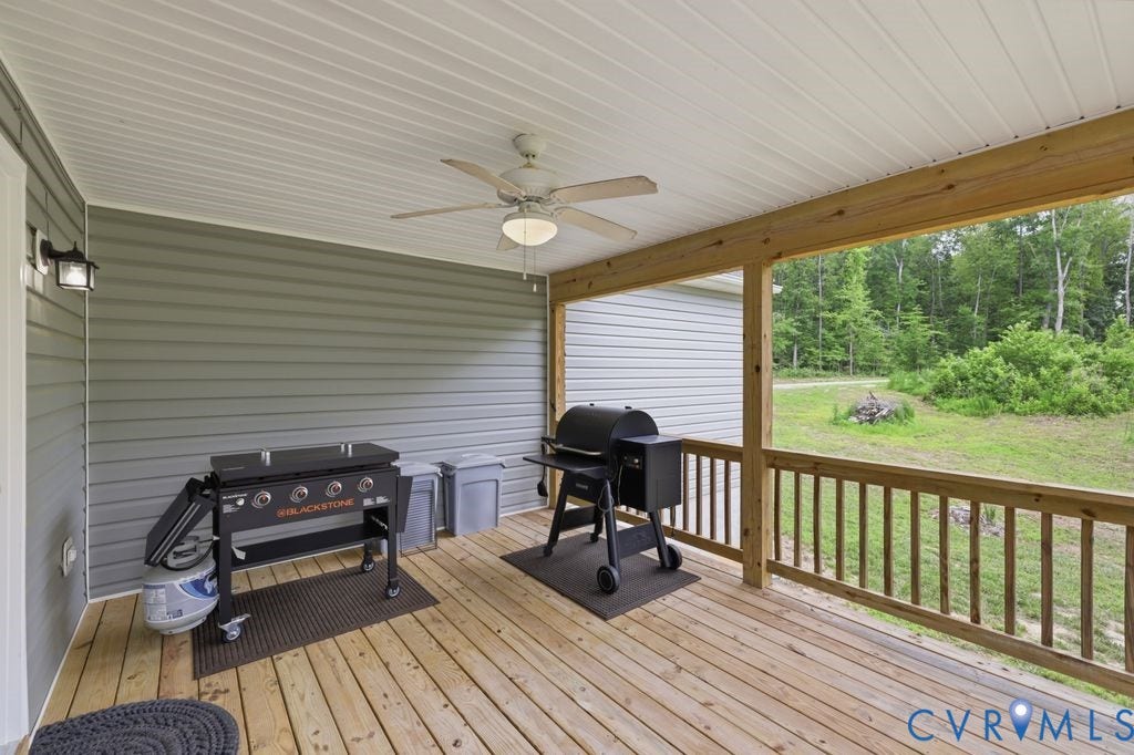 3259 Three Bridge Road, Powhatan, VA 23139 Covered porch featuring wood-finish decking, light gray siding, a white beadboard ceiling with a ceiling fan, and a wood railing