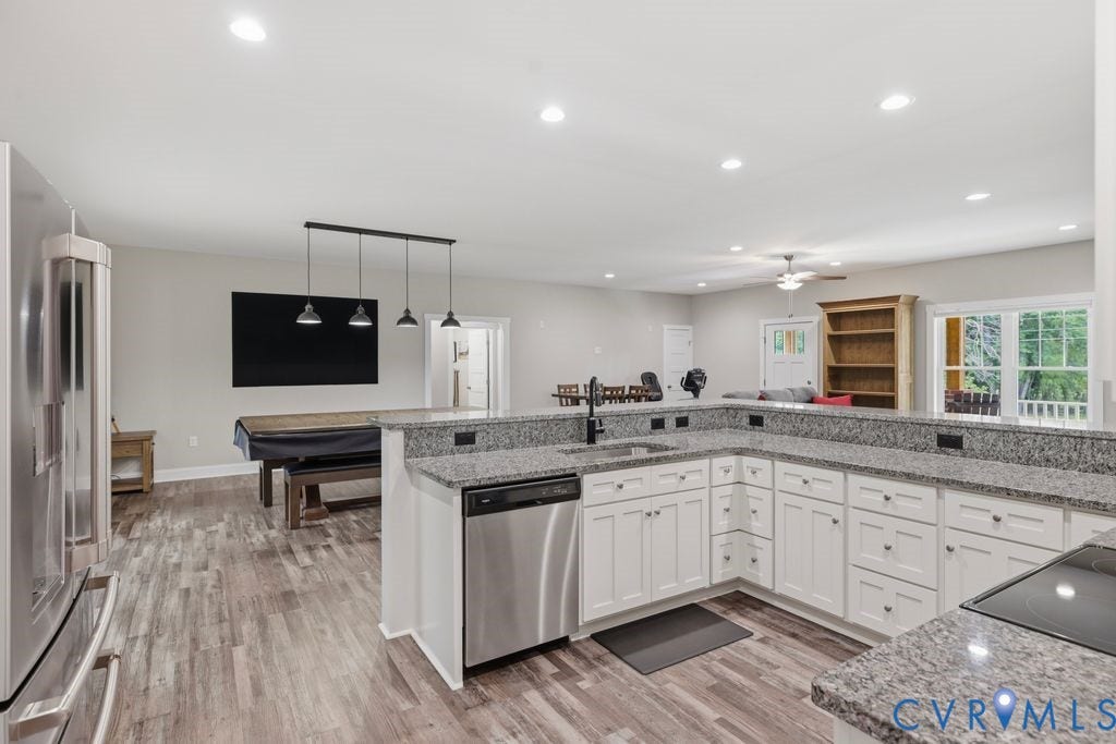 3259 Three Bridge Road, Powhatan, VA 23139 Modern kitchen featuring white cabinetry, stone countertops, stainless steel appliances, and wood-finish flooring