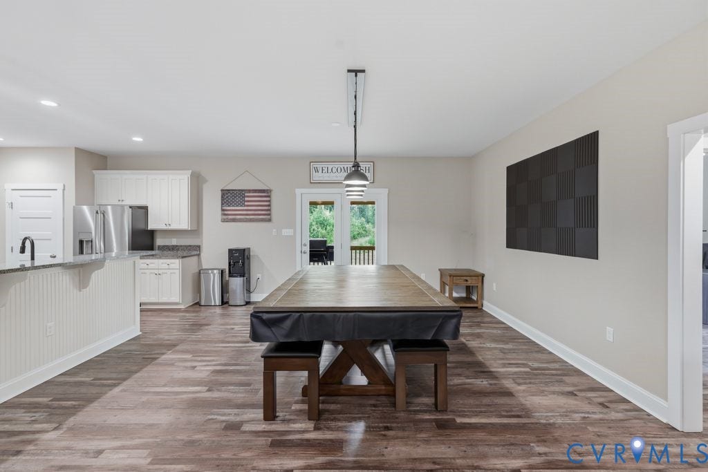 3259 Three Bridge Road, Powhatan, VA 23139 Open-concept recreation area featuring wood-finish flooring, recessed lighting, and a modern light fixture
