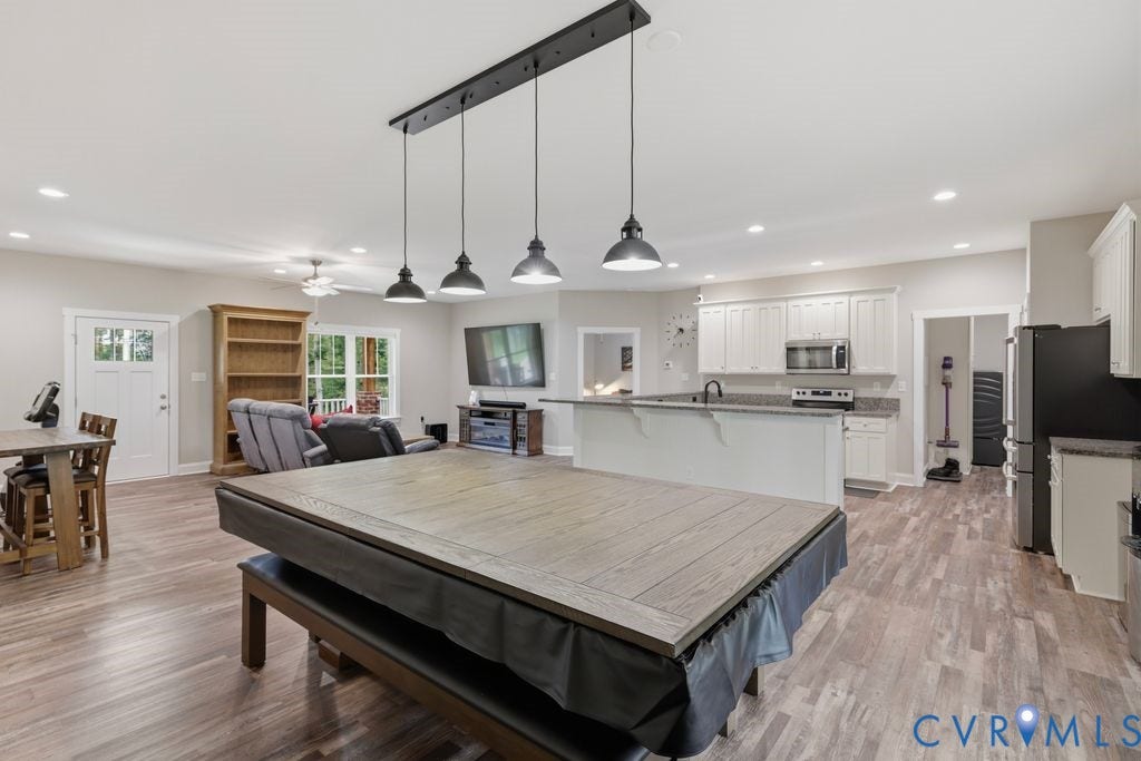 3259 Three Bridge Road, Powhatan, VA 23139 Open-concept living area featuring wood-finish flooring, recessed lighting, and a linear pendant fixture