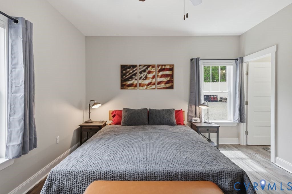 3259 Three Bridge Road, Powhatan, VA 23139 Spacious bedroom featuring light neutral walls and wood-finish flooring