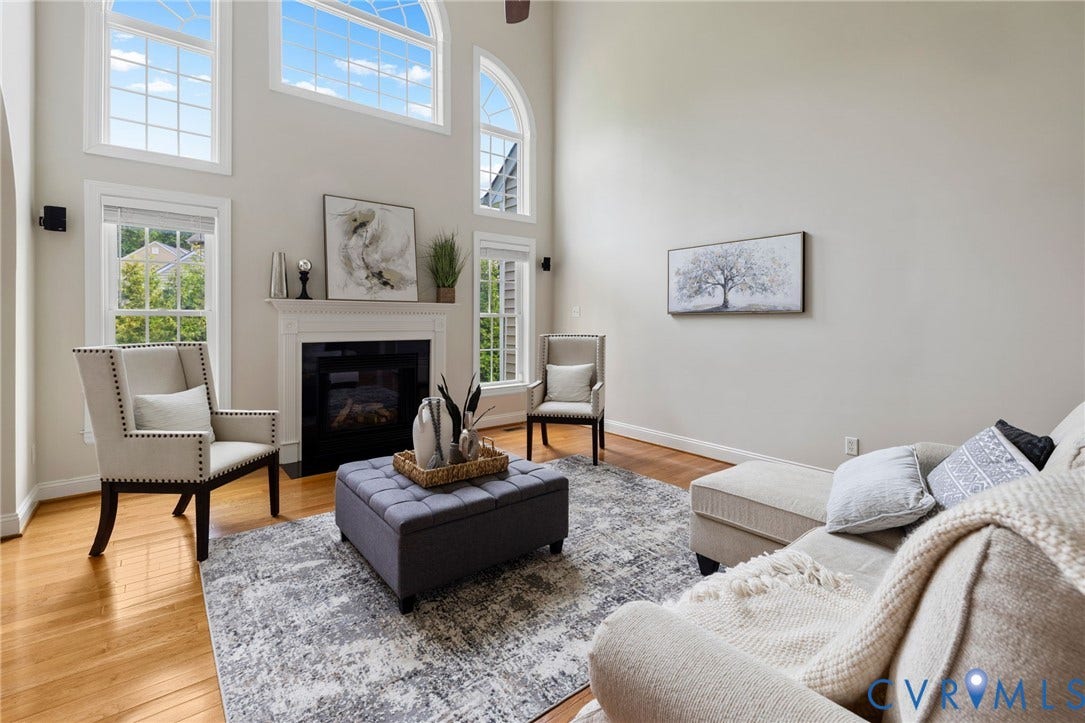 2936 Bayfront Way, Midlothian, VA 23112 2-story family room with lots of windows, wood floors, gas fireplace and a beautiful arched entranceway to the custom kitchen.