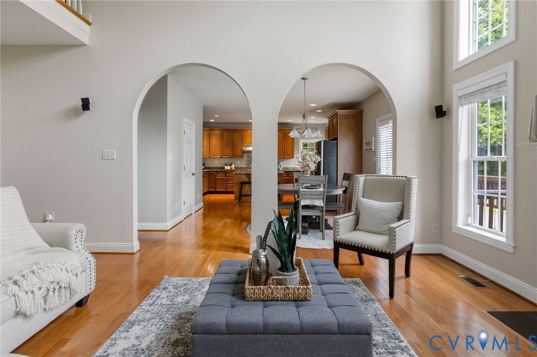 2936 Bayfront Way, Midlothian, VA 23112 2-story family room with lots of windows, wood floors, gas fireplace and a beautiful arched entranceway to the custom kitchen.