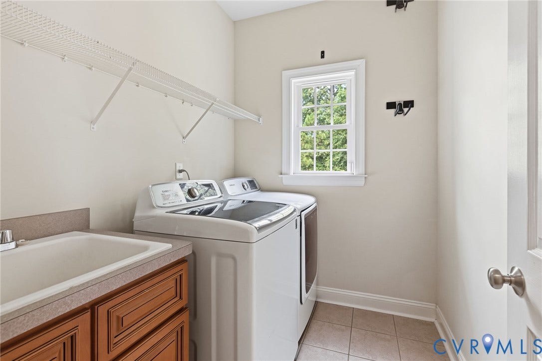 2936 Bayfront Way, Midlothian, VA 23112 Laundry room with ceramic tile floor, utility sink and cabinet.