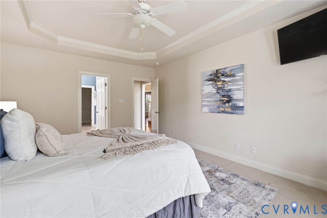 2936 Bayfront Way, Midlothian, VA 23112 First floor primary bedroom with trey ceiling, molding, ceiling fan and a huge walk-in closet.