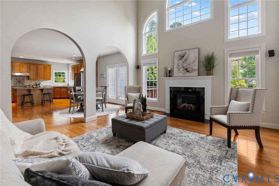 2936 Bayfront Way, Midlothian, VA 23112 2-story family room with lots of windows, wood floors, gas fireplace and a beautiful arched entranceway to the custom kitchen.