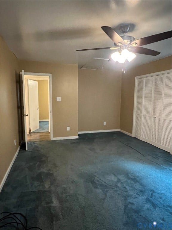 Room featuring teal carpeting, a ceiling fan with integrated lighting, and louvered bifold closet doors