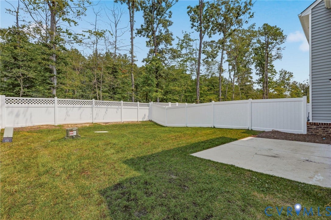 10880 Farmstead Mill Lane, Glen Allen, VA 23059 Expansive backyard with a white privacy fence, featuring a lattice top section