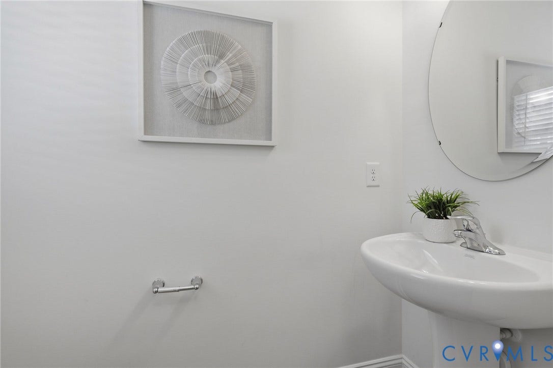 10880 Farmstead Mill Lane, Glen Allen, VA 23059 Pedestal sink with chrome faucet and circular mirror
