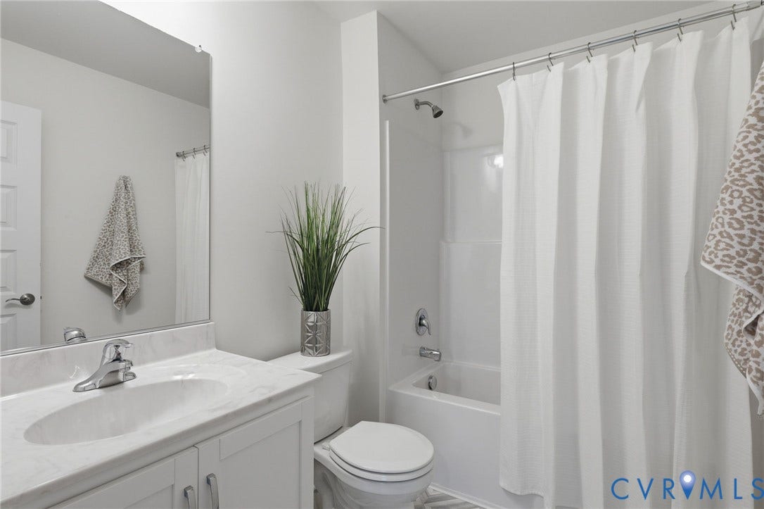 10880 Farmstead Mill Lane, Glen Allen, VA 23059 Bathroom featuring a white vanity with an integrated sink, polished chrome faucet, and a light-toned countertop