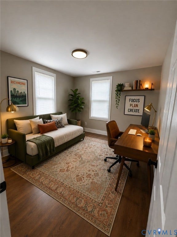 2108 Keswick Avenue, Richmond, VA 23224 Room featuring wood-finish flooring, two windows with blinds, a ceiling-mounted light fixture, and a built-in wall shelf