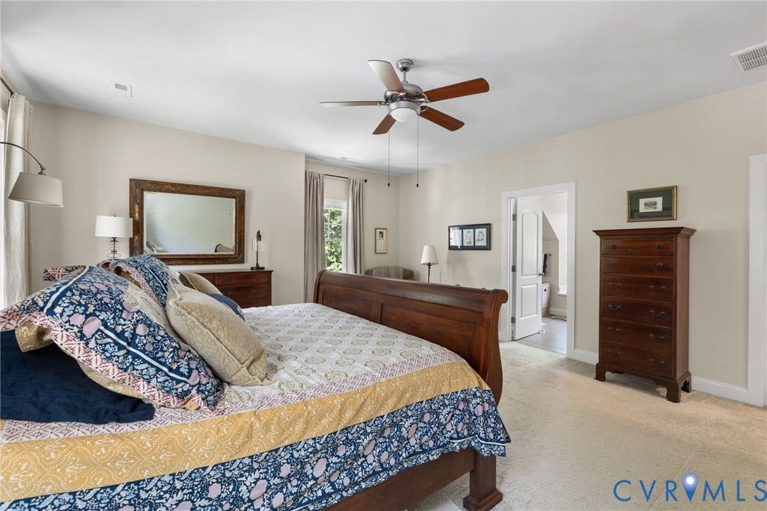 15936 Alsdell Road, Hallsley, Midlothian, VA 23112 Spacious room featuring neutral wall tones, light-colored carpeting, a ceiling fan with wood-finish blades, and a door opening to another interior space