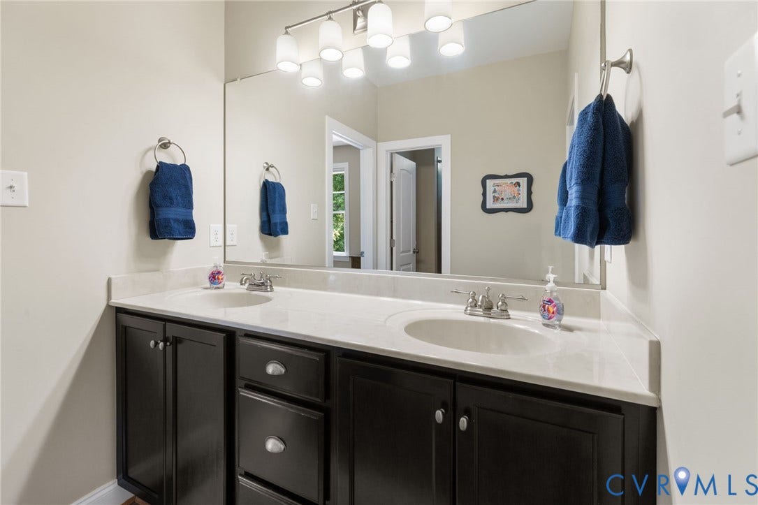 15936 Alsdell Road, Hallsley, Midlothian, VA 23112 Dual undermount sinks set into a light-toned countertop, complemented by dark wood-finish cabinetry