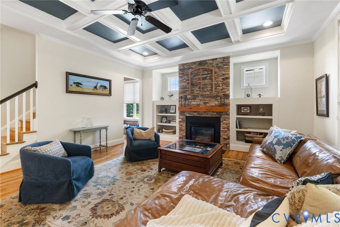 15936 Alsdell Road, Hallsley, Midlothian, VA 23112 Living area featuring a stone-clad fireplace with a wood mantel, built-in shelving, and a coffered ceiling with a ceiling fan