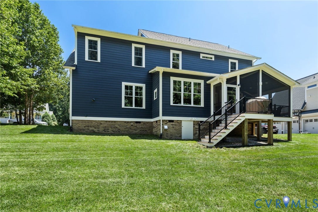 15936 Alsdell Road, Hallsley, Midlothian, VA 23112 Expansive rear yard featuring a large screened porch, exterior stairs with black metal railings, and a lower-level access door
