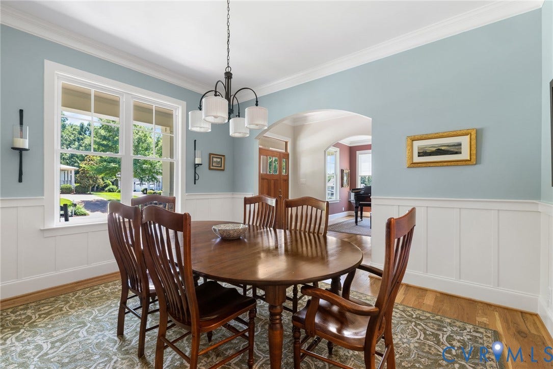 15936 Alsdell Road, Hallsley, Midlothian, VA 23112 Formal dining space featuring hardwood flooring, white wainscoting, and a multi-pane window
