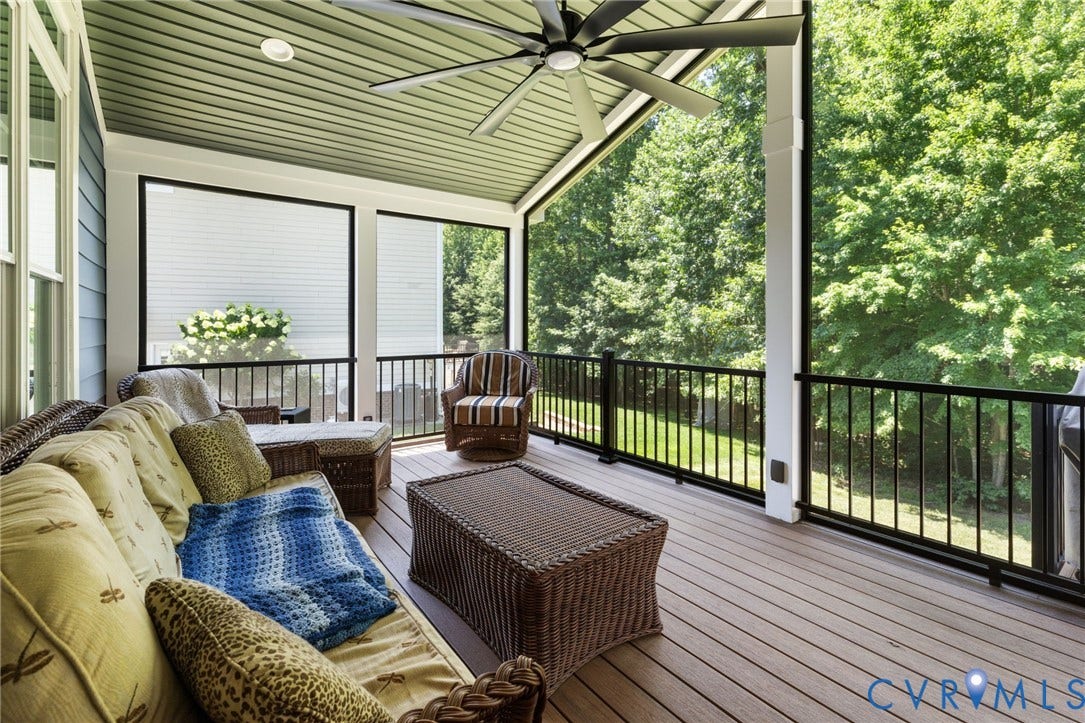 15936 Alsdell Road, Hallsley, Midlothian, VA 23112 Screened porch featuring a wood-finish floor, black metal railings, and a ceiling fan