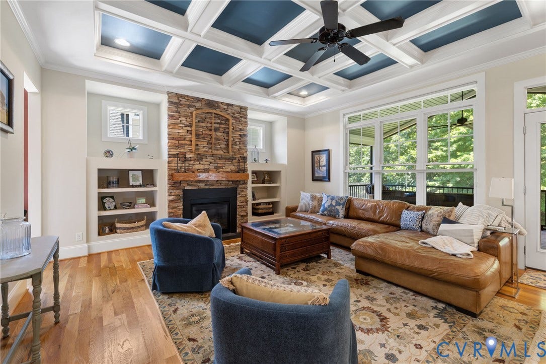 15936 Alsdell Road, Hallsley, Midlothian, VA 23112 Living area featuring a coffered ceiling with recessed lighting, a stone-clad fireplace with a wood mantle, built-in shelving, hardwood flooring, and large windows