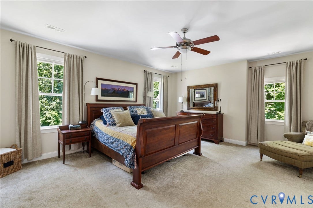15936 Alsdell Road, Hallsley, Midlothian, VA 23112 Spacious sleeping area featuring light-toned carpeting, multiple windows providing natural light, crown molding, and a ceiling fan with integrated lighting