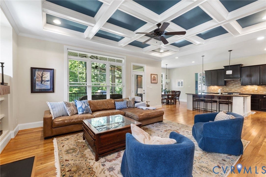 15936 Alsdell Road, Hallsley, Midlothian, VA 23112 Spacious living area featuring a coffered ceiling with recessed lighting and a ceiling fan, hardwood flooring, and large windows overlooking exterior greenery
