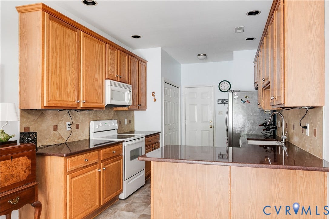 130 Carriage Point Lane, Henrico, VA 23059 Kitchen Featuring Stainless-Steel Refrigerator, Oven, and Microwave.
