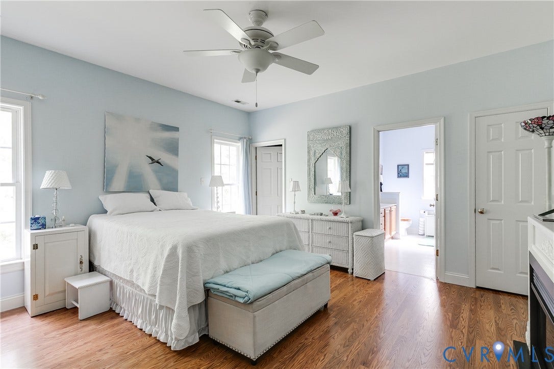130 Carriage Point Lane, Henrico, VA 23059 Primary Bedroom Featuring Vinyl Wood Flooring, Ceiling Fan, and Large Walk-In Closet.