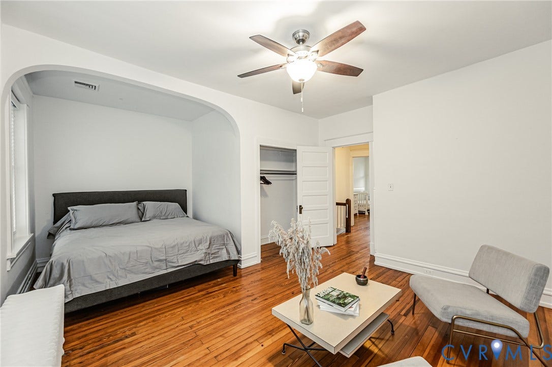 Room featuring wood flooring and a ceiling fan with integrated lighting